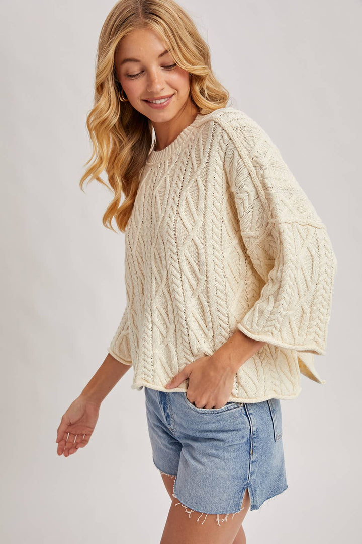 OVERSIZED BELL SLEEVE CABLE KNIT SWEATER