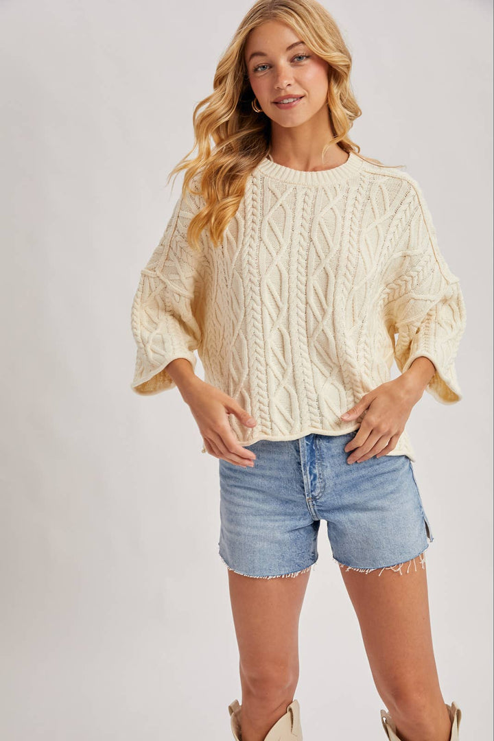 OVERSIZED BELL SLEEVE CABLE KNIT SWEATER